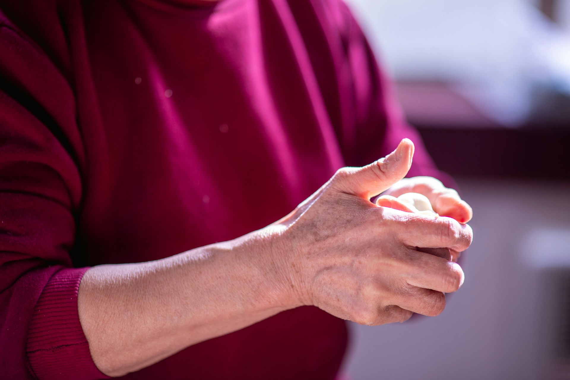 Close-up of hands showing signs of joint stiffness